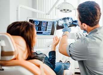Dentist showing patient her X-rays