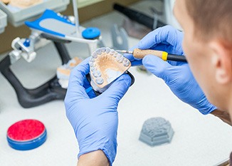 Lab technician carving dentures