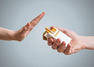 One hand refusing a cigarette offered by another