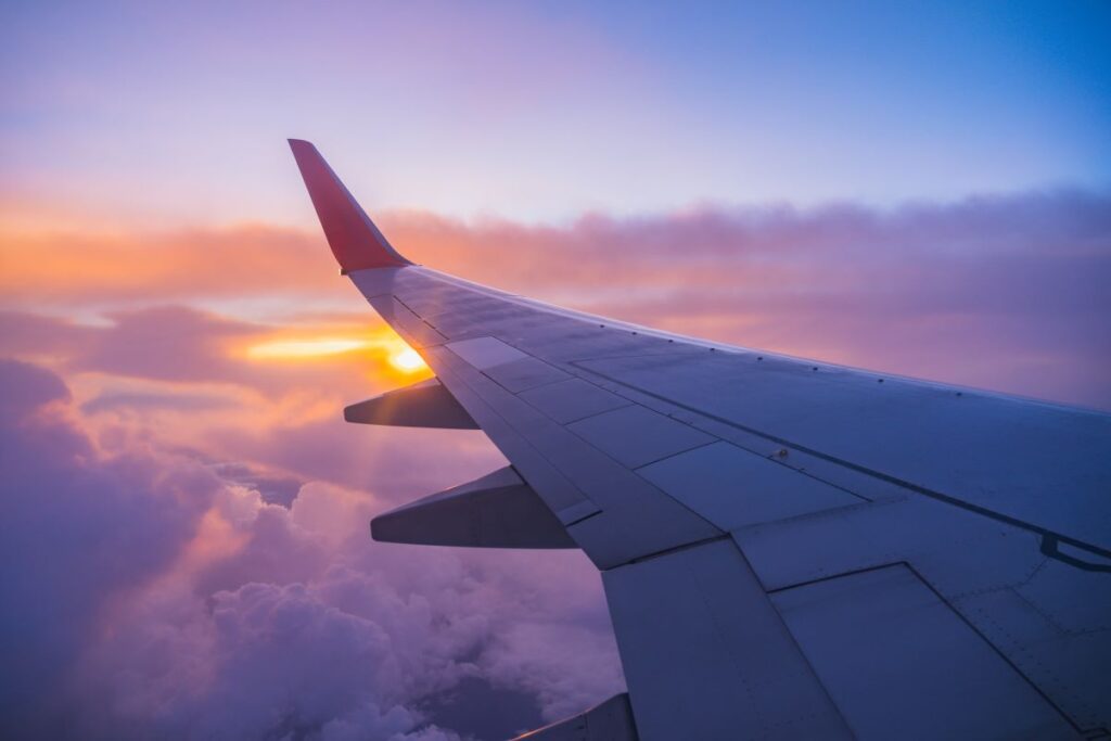 An airplane wing in the clouds